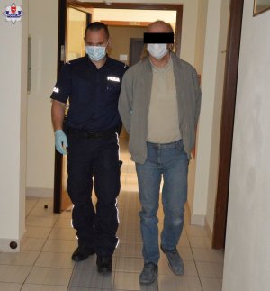 Policjant z zatrzymanym mężczyzną