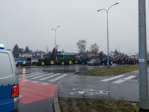 Radiowozy i ciągniki rolnicze na ulicy.