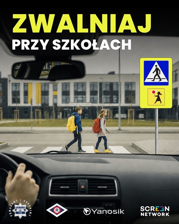 plakat z napisem zwolnij przy szkołach
